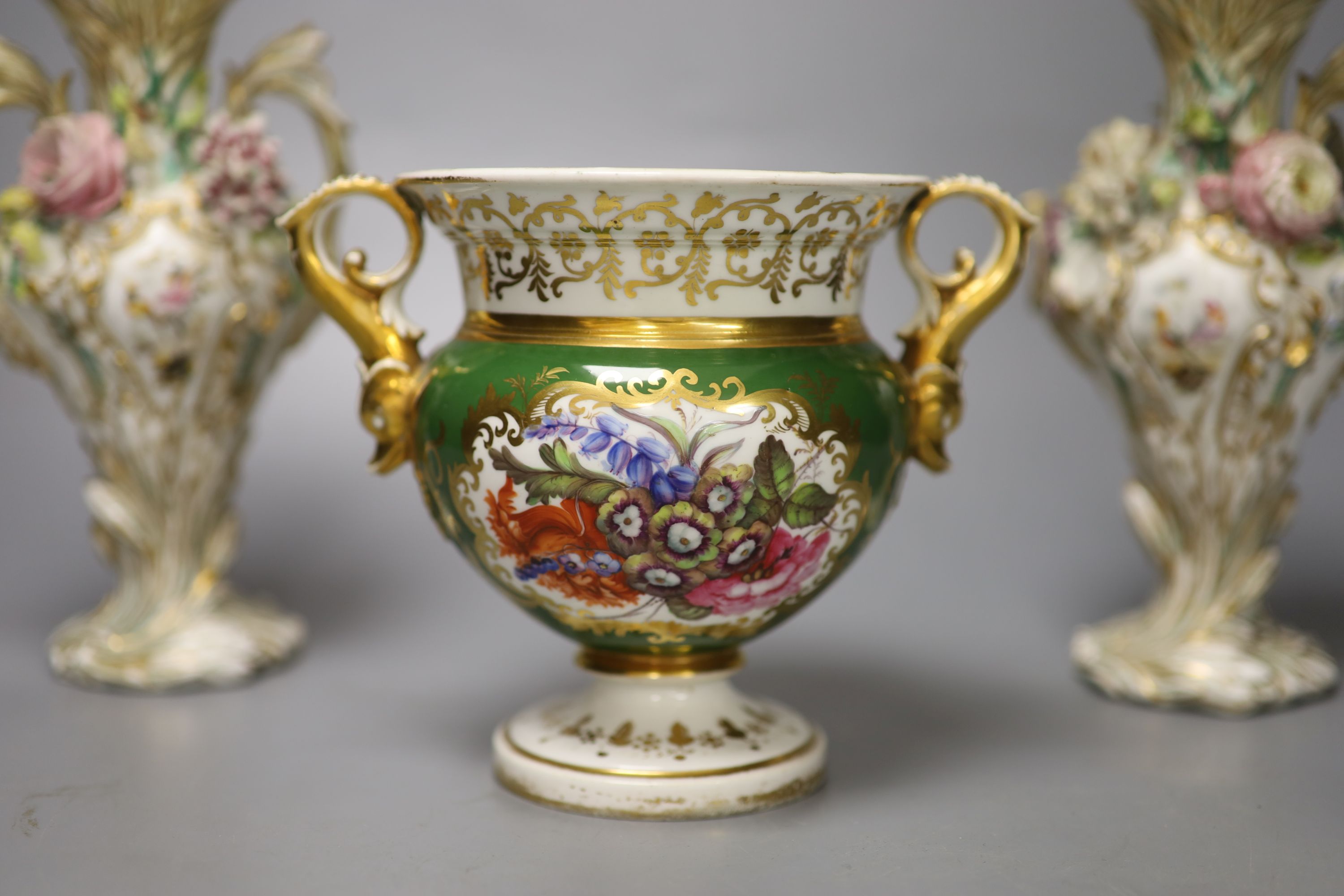 An English porcelain two handled green ground vase and a pair of floral encrusted vases, 20cm